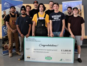 Group of students with a cheque